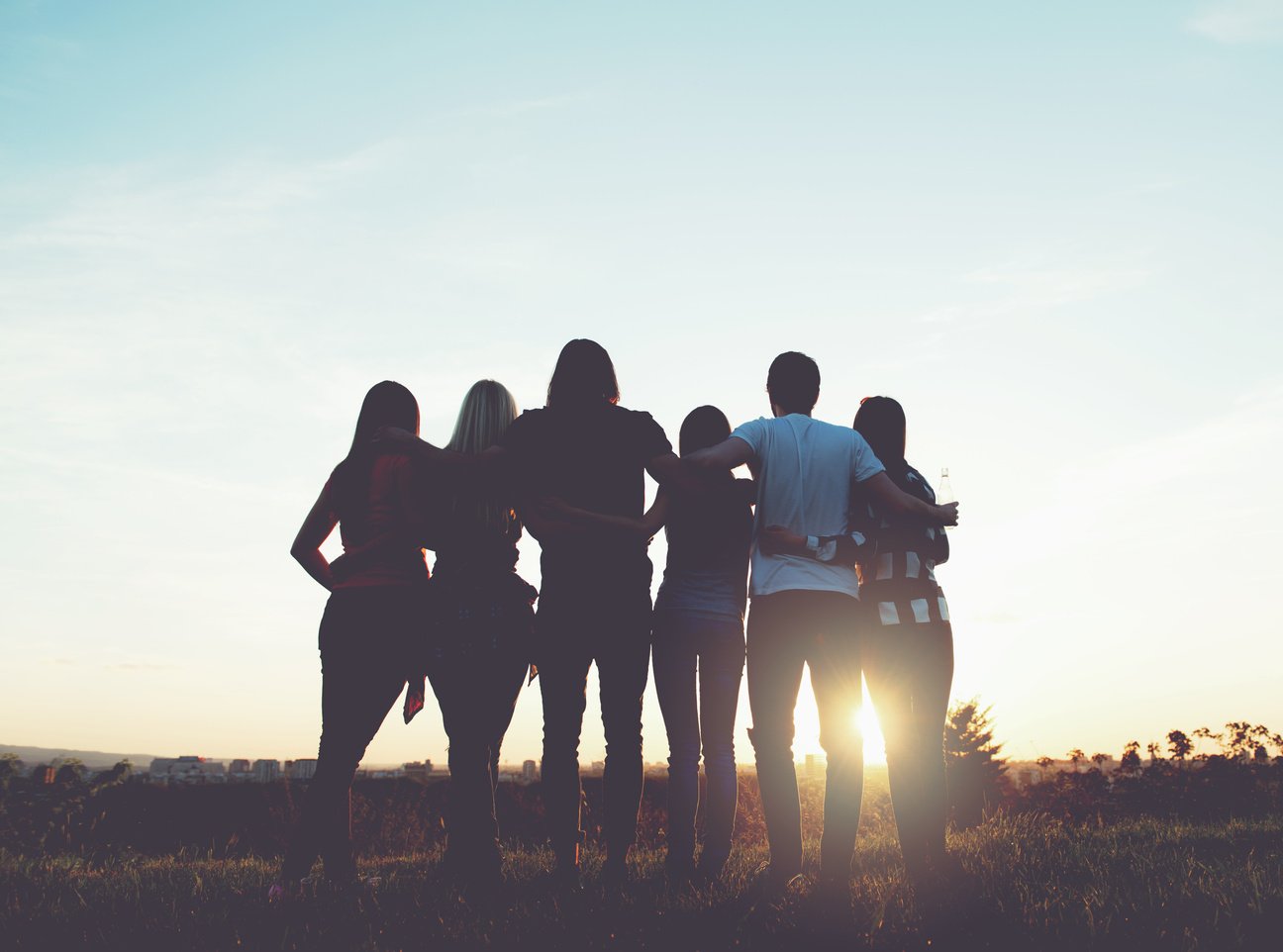 Group of people having fun outdoors; sunset